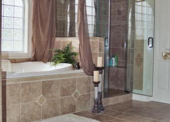 A bathroom with a tub, shower and tiled walls.
